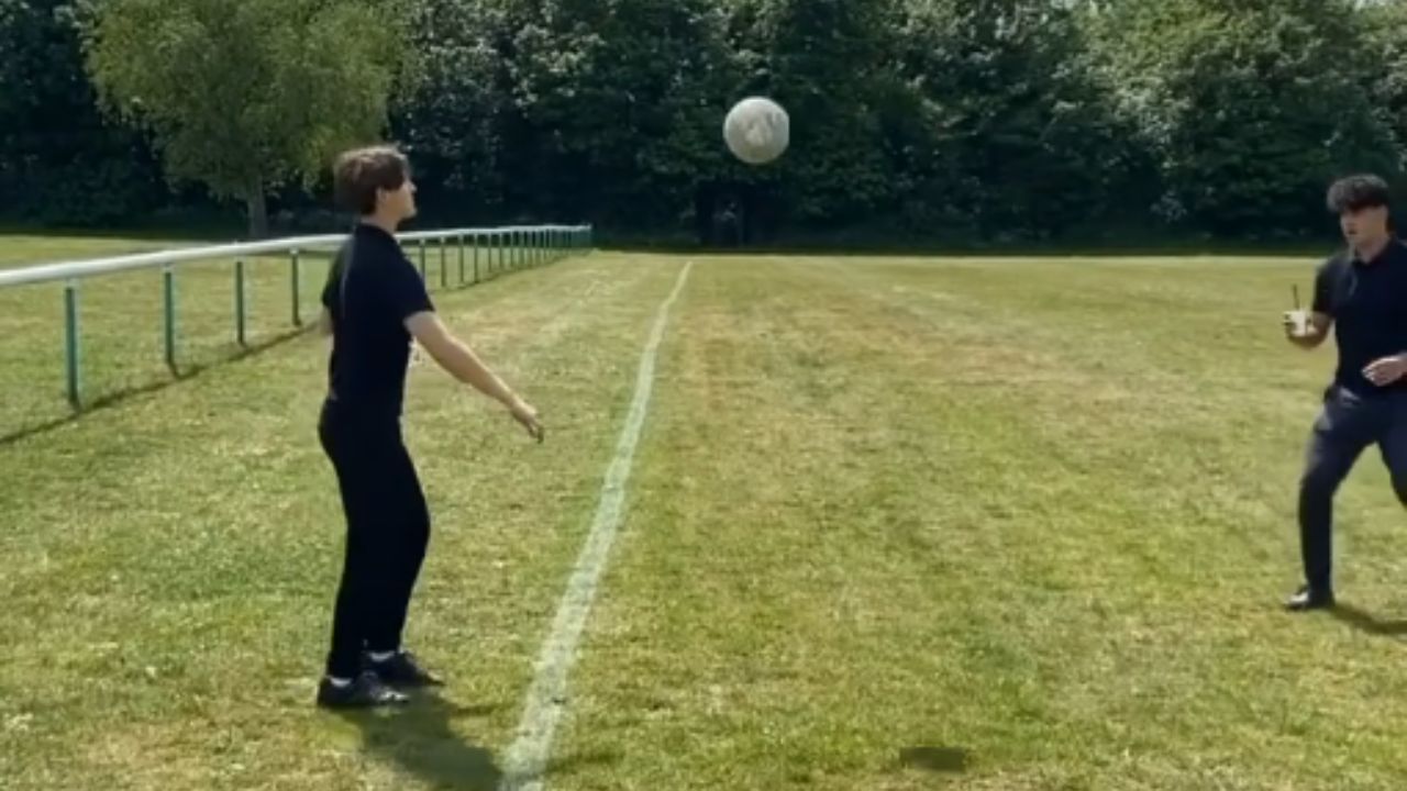 Boy jumps over fence to retrieve football but ends up tripping over it
