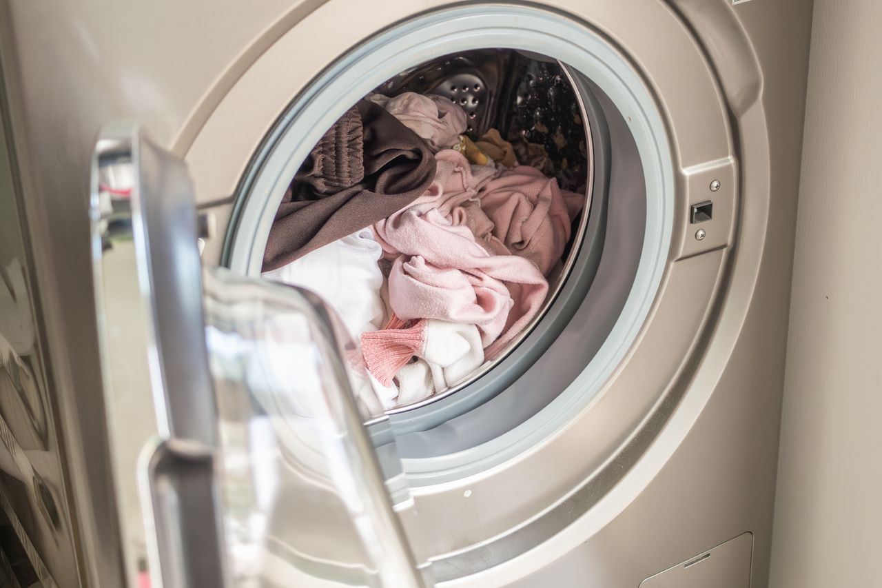 Washing machine loaded with clothes close up
