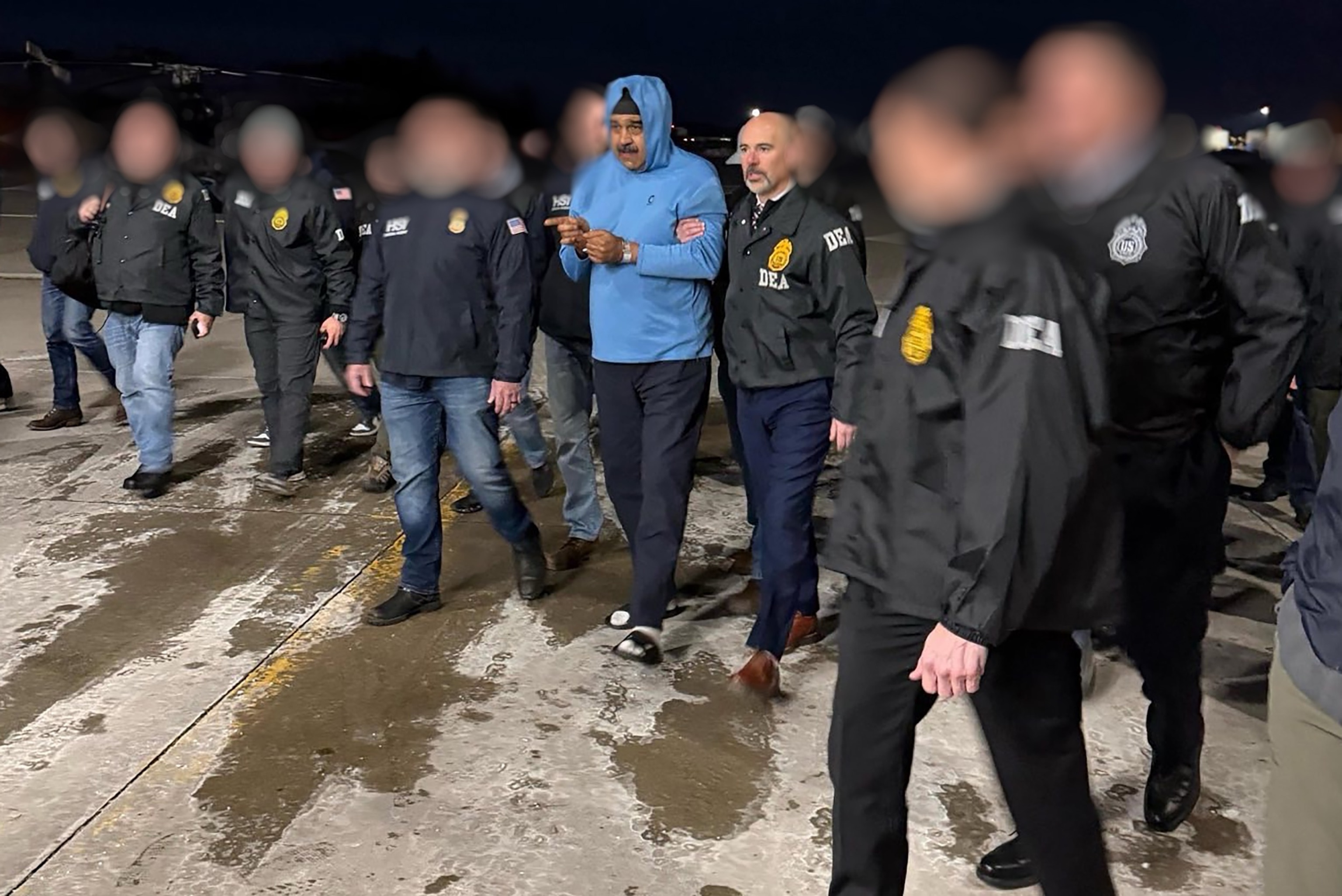 Obtained by ABC News - PHOTO: Venezuela's President Nicolas Maduro is escorted by Administrator of the U.S. Drug Enforcement Administration, Terry Cole after arriving at Stewart Air National Guard Base in Newburgh, New York, January 3, 2026.