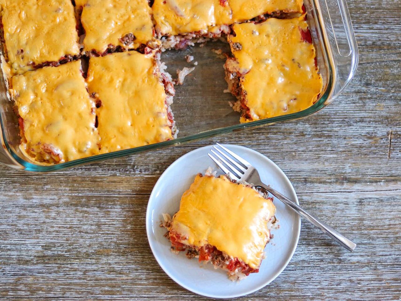 Hamburger rice casserole topped with melted cheese