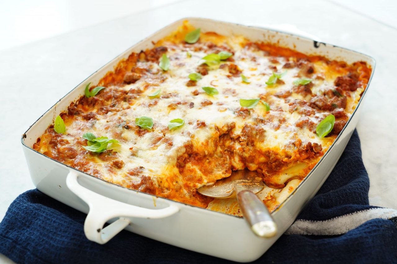 homemade baked lasagna with ricotta bechamel sauce in a casserole dish