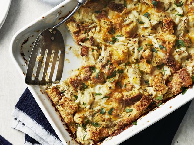 top-down view of Crab Brunch Casserole in a 9x13 baking dish with a serving taken out and a spatula in the corner