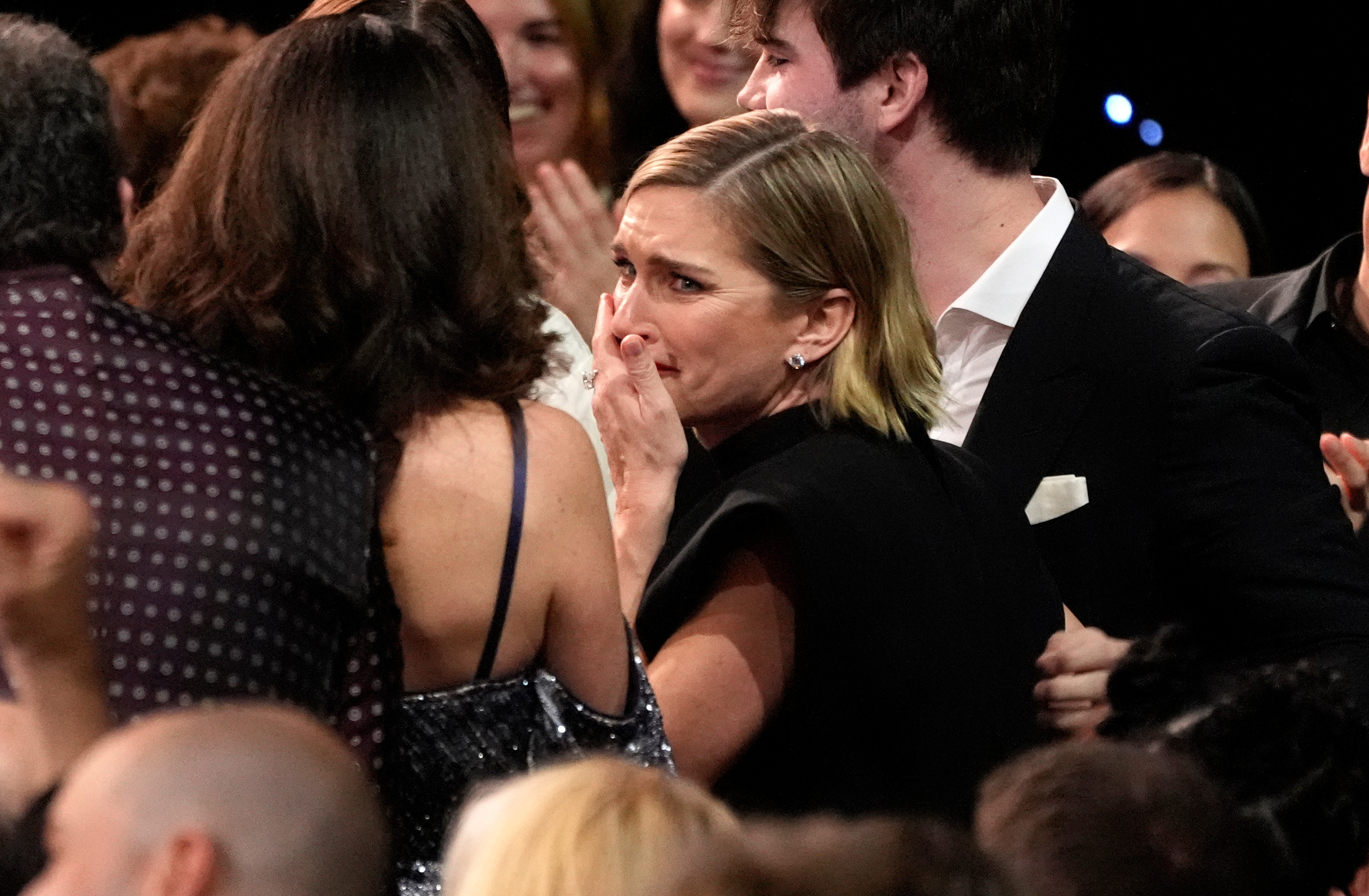 Rhea Seehorn, center, reacts to winning the award for best actress in a drama series for "Pluribus" during the Critics Choice Awards earlier this month.