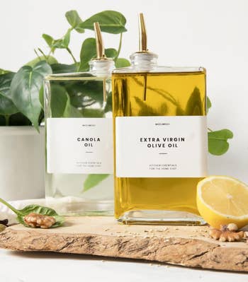 two slim, square bottles of oil, with gold spouts and labels that read Canola Oil and Extra Virgin Olive Oil