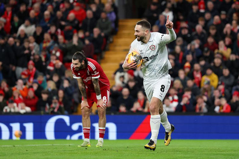 Adam Phillips of Barnsley celebrates scoring his team's first goal as Dominik Szoboszlai of Liverpool reacts