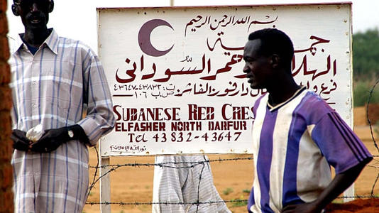 Workers outside the Sudanese Red Crescent compound in al-Fasher, North Darfur, Sudan, 3 August 2004
