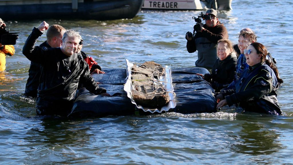 Researchers at the Wisconsin Historical Society (WHS) with one of the submerged canoes in Lake Mendota.