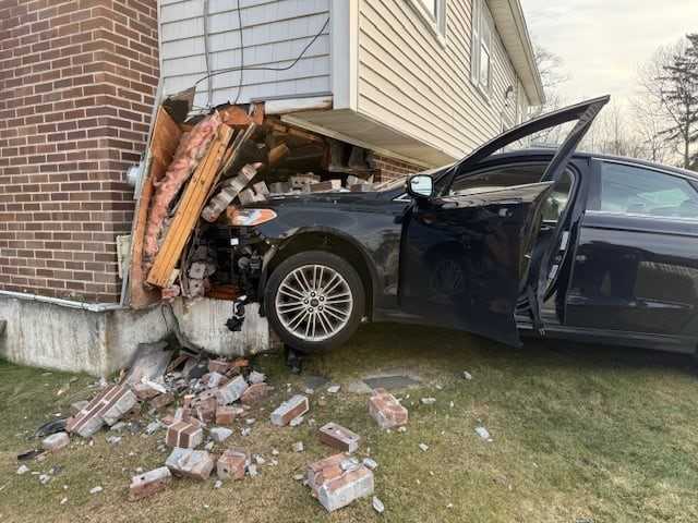 1 taken to hospital after car crashes into Mass. home