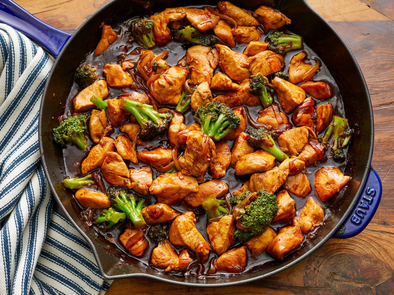overhead angle looking down at a cast iron skillet of broccoli and chicken stir-fry