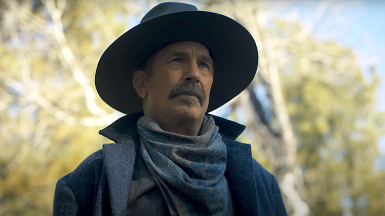 Hayes Ellison (Kevin Costner) looks sullenly up in a forest in Horizon: An American Saga - Chapter 1