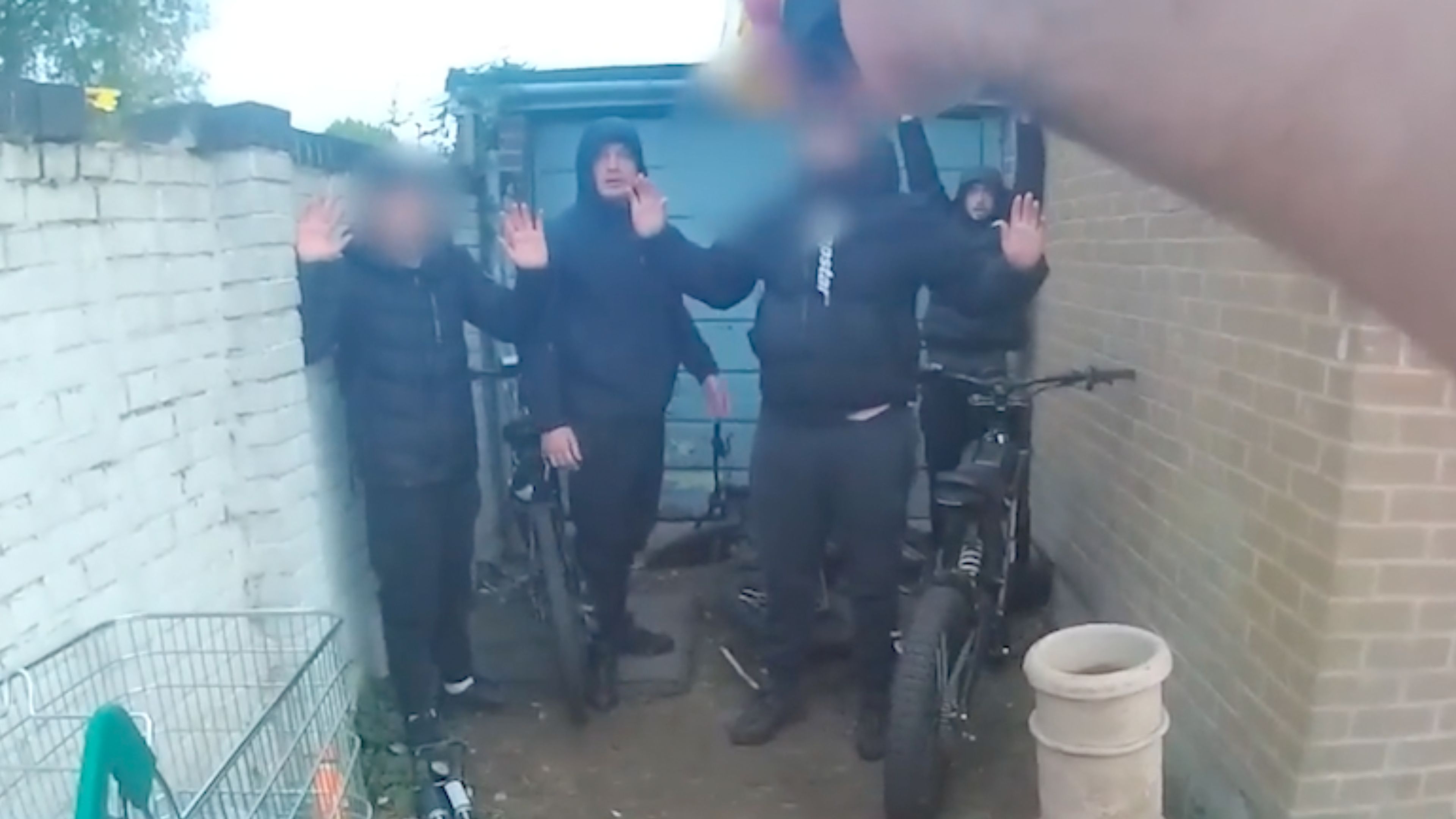 Moment bungling drug dealers caught after trying to hide in garage