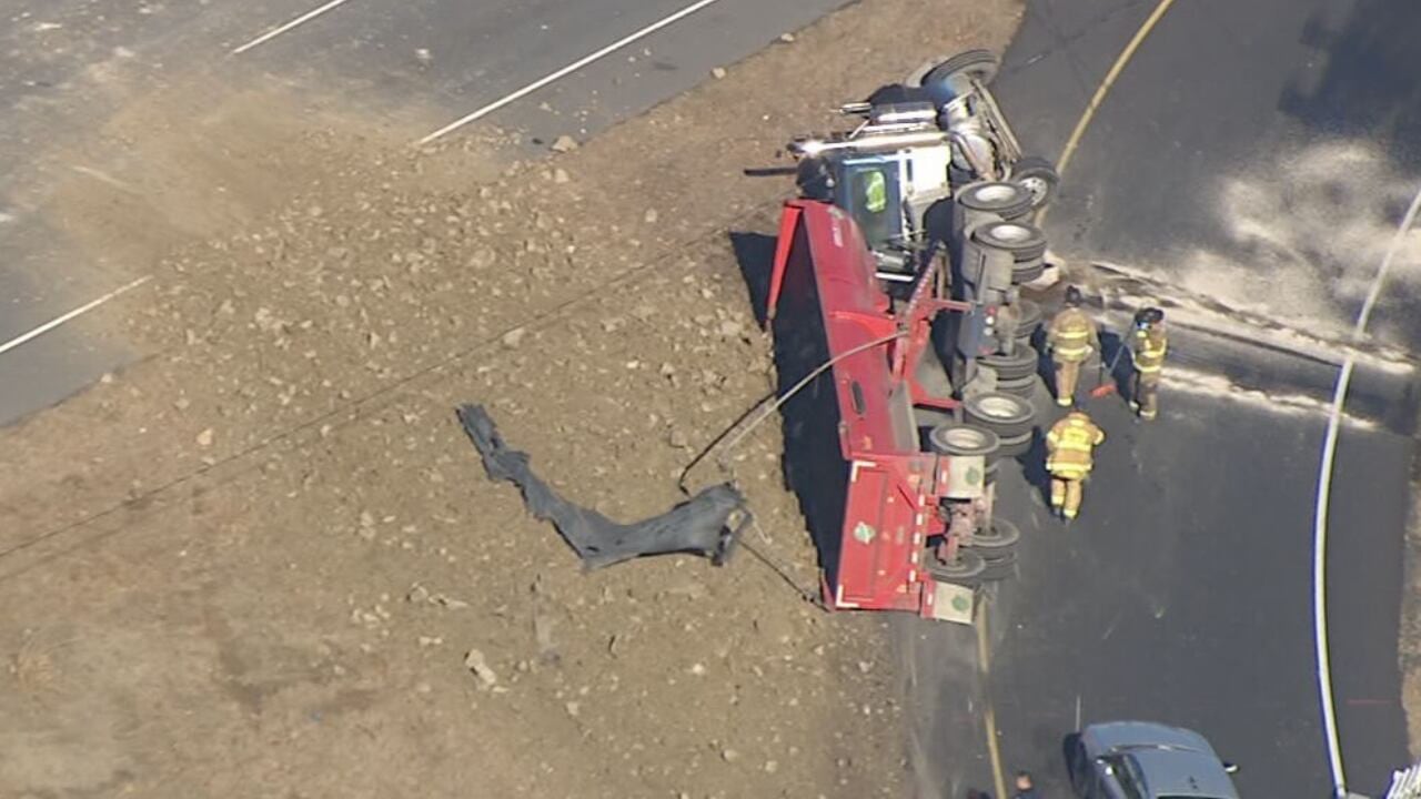 1 hurt after tractor-trailer rolls over on I-485 ramp