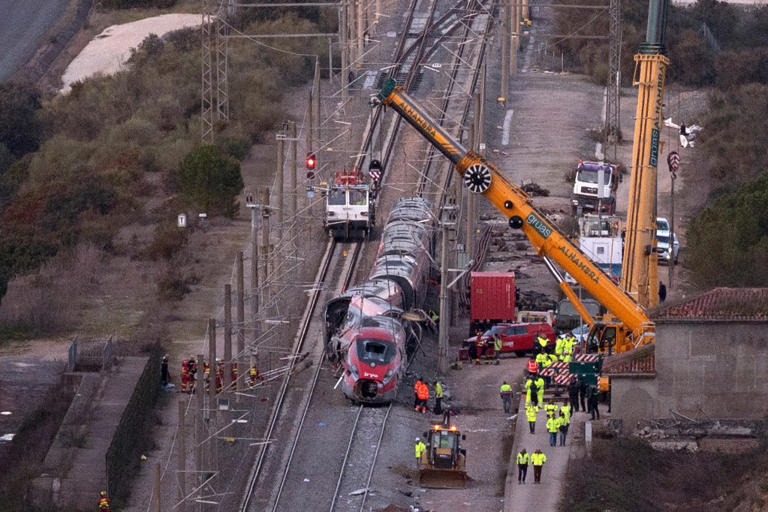 Emergency services and investigators work at the site of a high-speed train collision that killed at least 42 people in Adamuz on January 20.