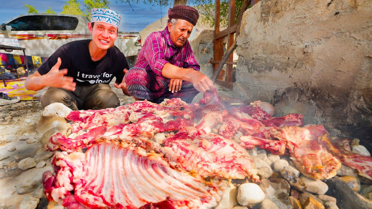 Cooking a whole goat inside hot rocks in the Arabian desert