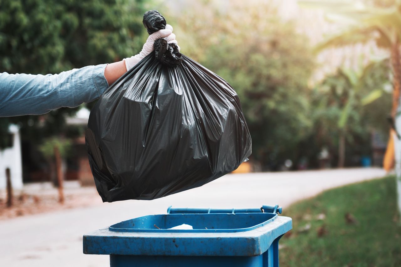 Throwing Trash Away in Garbage Can