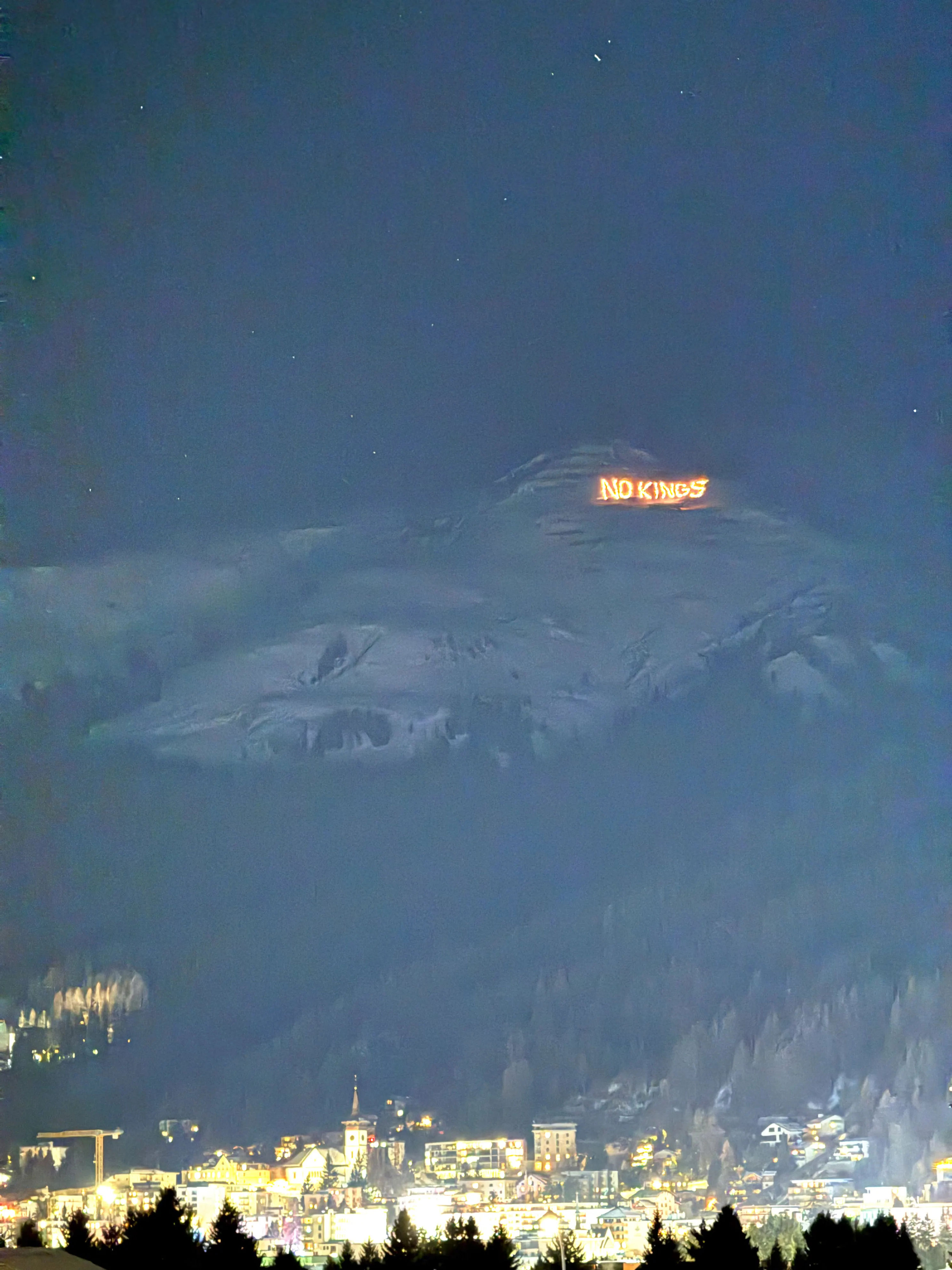 Trump confronted at Davos with giant 'No Kings' message on mountain