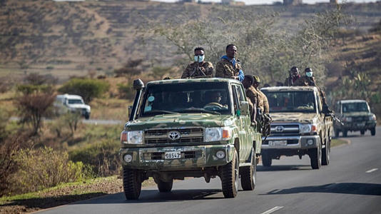 Archive photo from 8 May 2021: Ethiopian government soldiers travel in the back of trucks on a road near Agula, north of Mekele, in the Tigray region.