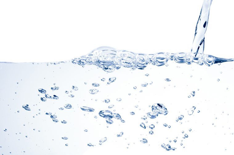 Water drinking splash and bubbles on white background