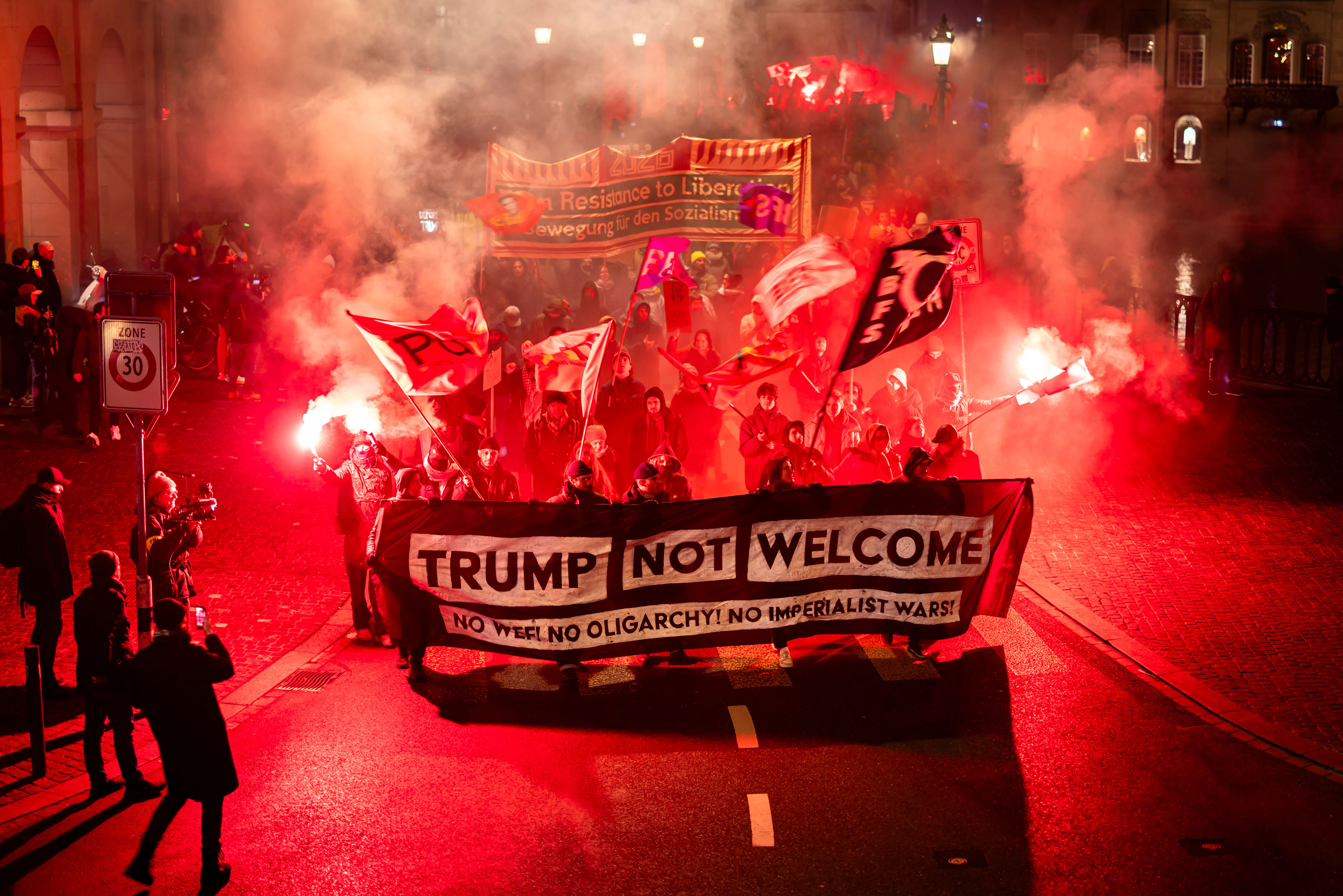 Anti-Trump protesters burn US flags in Switzerland
