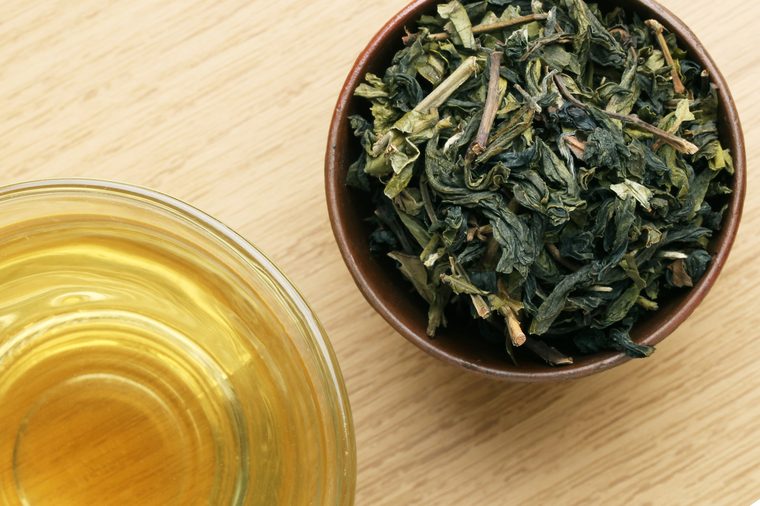 Cup with green tea on wooden background.View from the top.
