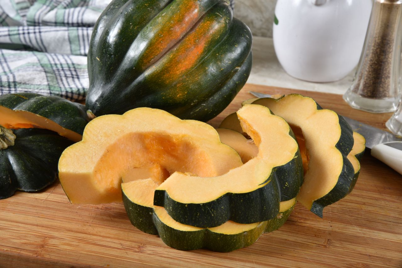 Sliced acorn squash displayed on a cutting board
