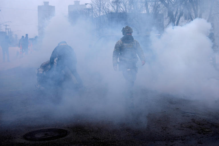 Leah Millis/Reuters - PHOTO: Federal agents hold a person down as they are surrounded by tear gas used to deter protesters in Minneapolis, Minnesota, January 21, 2026.