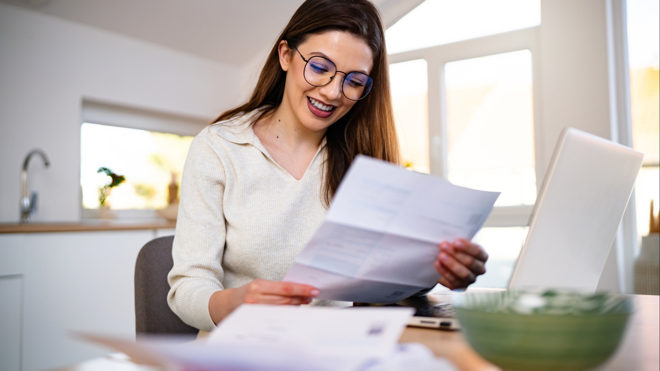 Smiling woman paying her bills