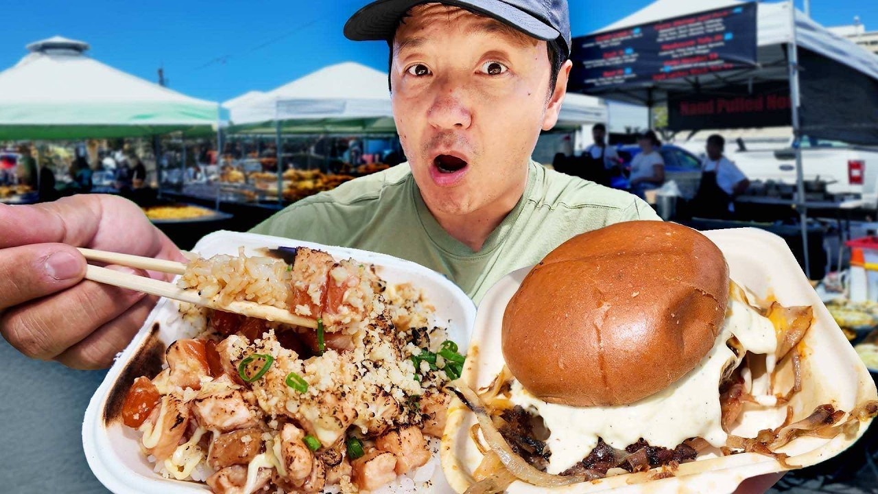 Colorful food stalls line an open-air market in Honolulu