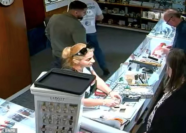 Blink and you'd miss it: Claudia Rostas is seen swiping the diamond ring from the box in the seconds that a staff member has turned her head