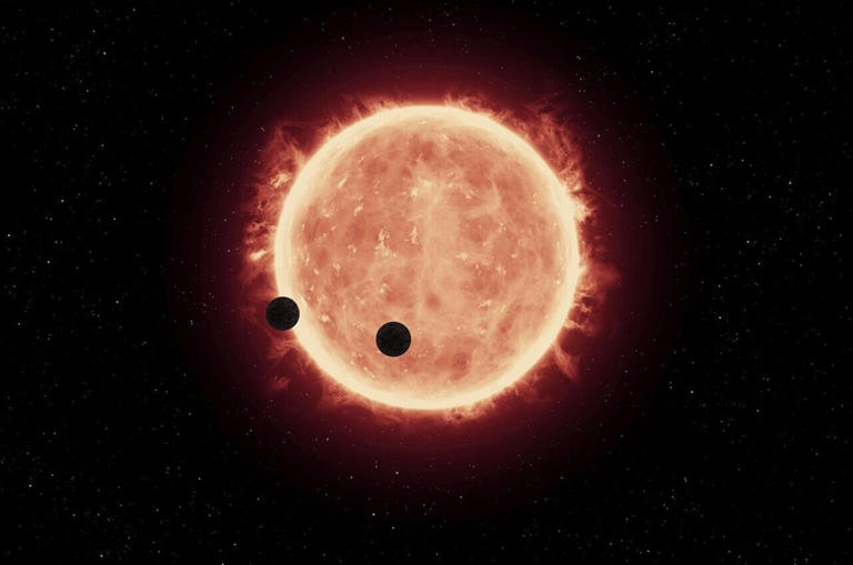This artist's impression shows the star TRAPPIST-1 with two planets transiting across it. ExoMiner++, a recently updated open-source software package developed by NASA, uses artificial intelligence to help find new transiting exoplanets in data collected by NASA&rsquo;s missions. Credit: NASA, ESA, and G. Bacon (STScI)