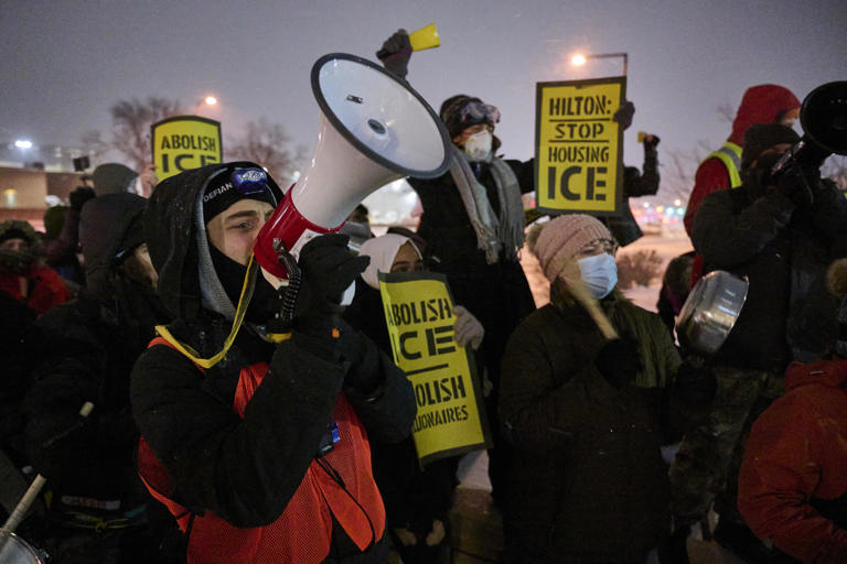 People gather for a noise protest outside a hotel where they believe Immigration and Customs Enforcement agents are staying on Jan. 16 in Bloomington, Minn.
