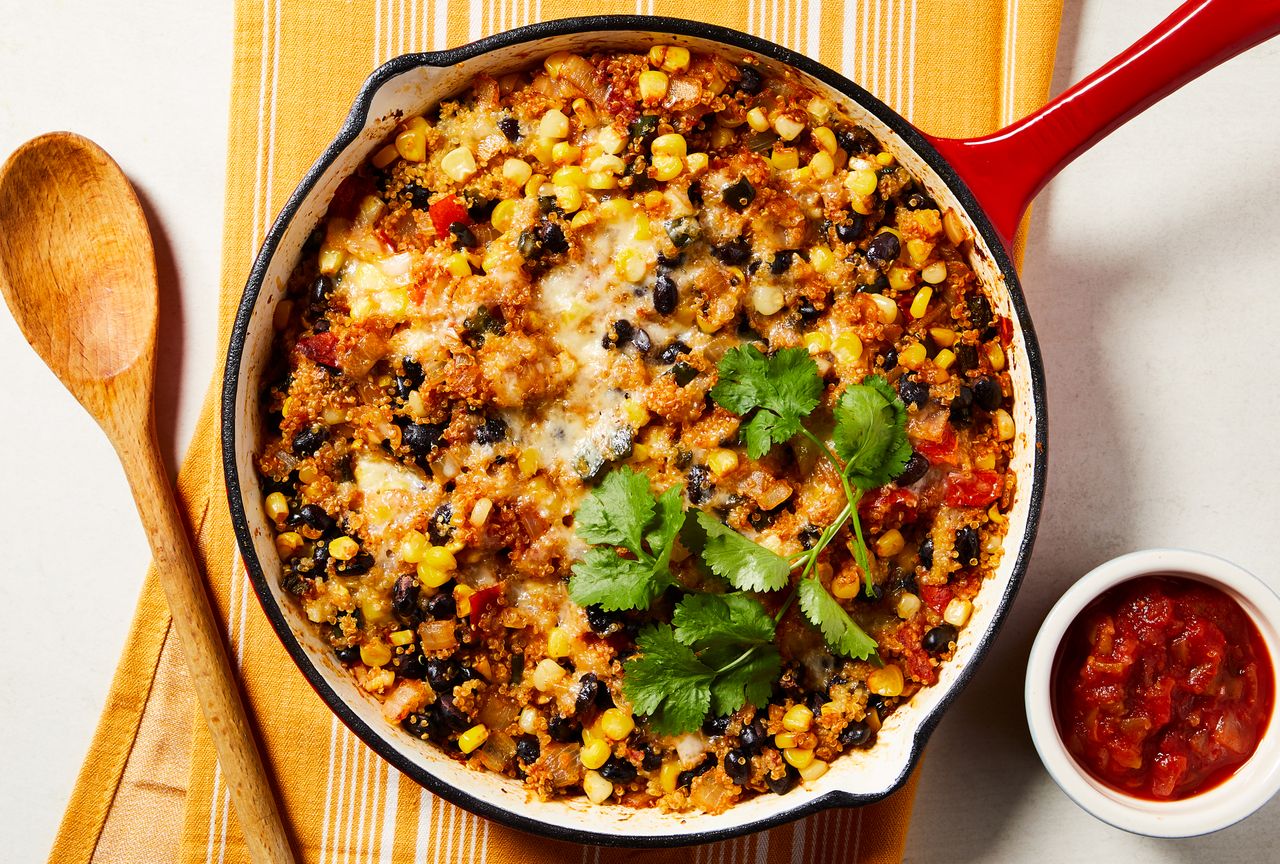 Overhead view of a cast iron skillet of Cheesy Black Bean & Quinoa Skillet Casserole recipe