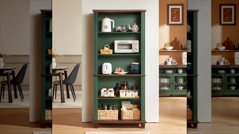 A green wooden bookcase in a kitchen holding food and small appliances