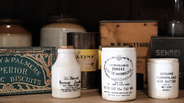 Vintage ceramic crocks and tins on a shelf
