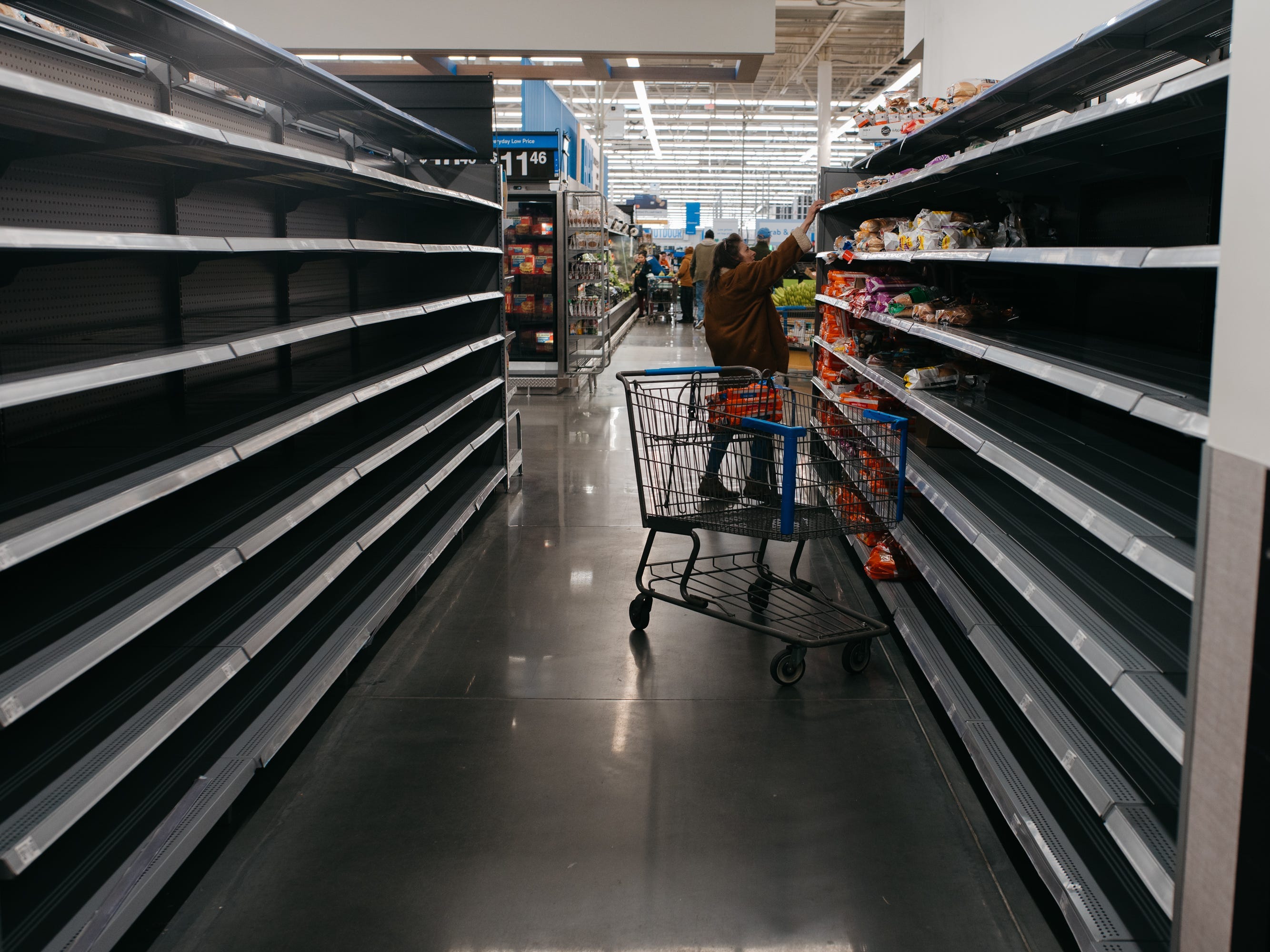 Photos show empty supermarket shelves as millions across the US brace for Winter Storm Fern