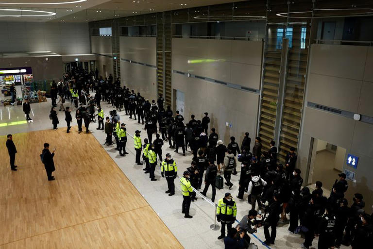 Police officers escort South Koreans allegedly involved in scam operations in Cambodia after being forcibly repatriated from Cambodia, at Incheon International Airport in Incheon, South Korea January 23, 2026. REUTERS/Kim Soo-hyeon