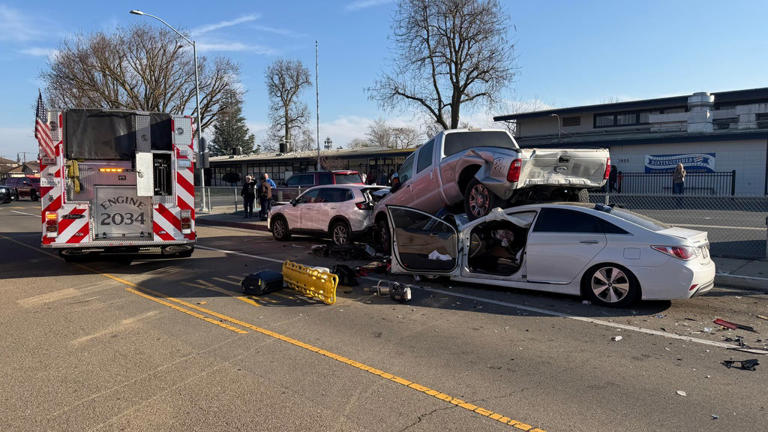 Adult, child injured after car slams into parked vehicles in front of ...
