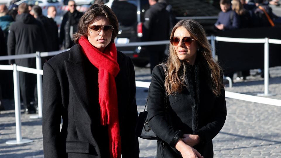 Actor Liz Hurley and her son Damian Hurley, wearing a scarlet red scarf in honour of Valentino's signature hue. - Yara Nardi/Reuters