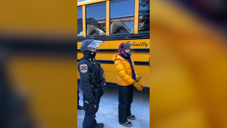 Law enforcement load protesters into school buses at MSP