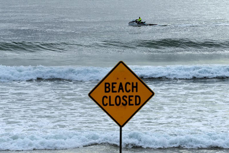 A beach closure sign at North Steyne Beach following another shark attack on Monday.