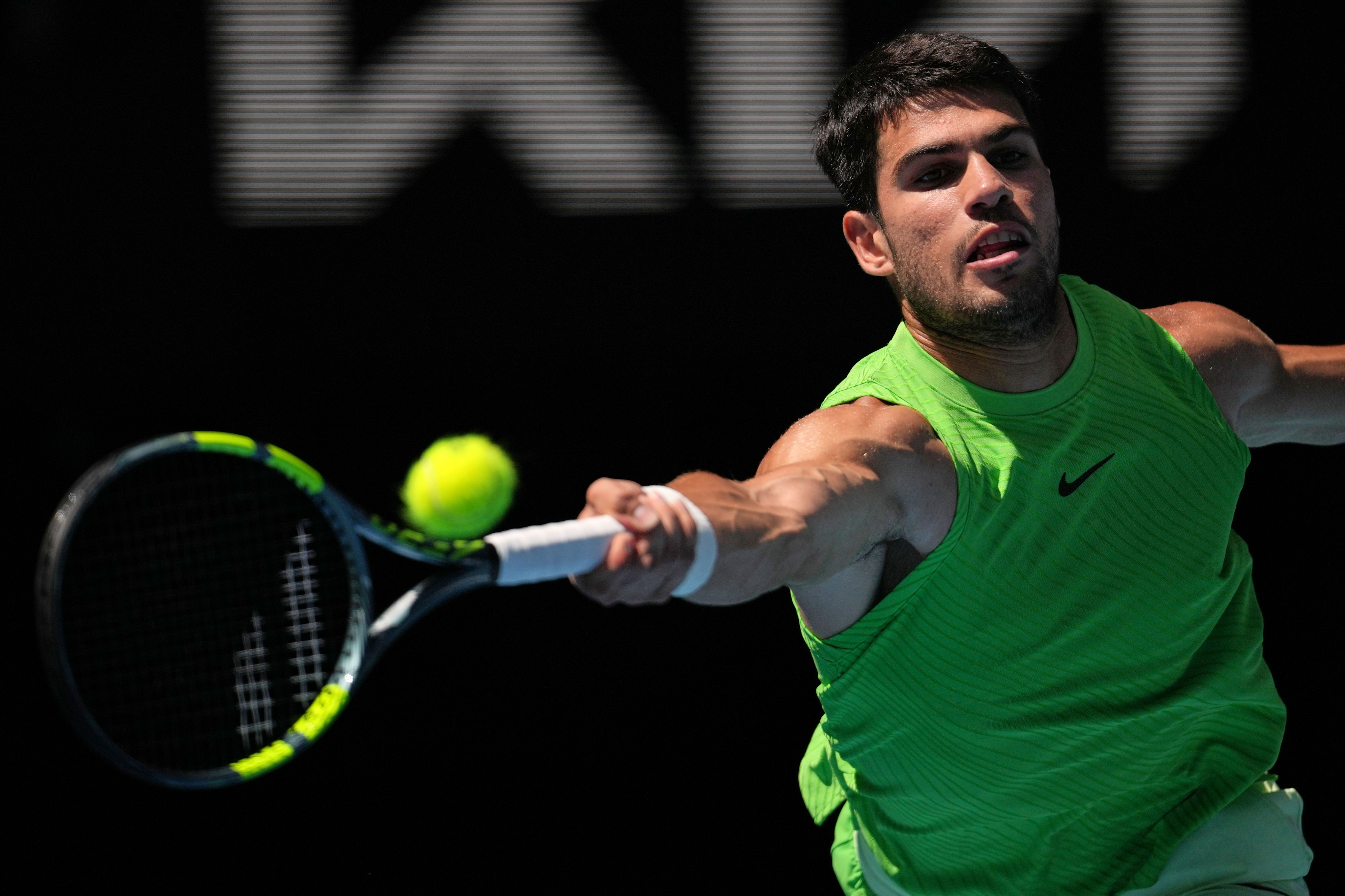 Carlos Alcaraz of Spain plays a forehand return to Tommy Paul of the U.S. during their fourth round match at the Australian Open tennis championship in Melbourne, Australia, Sunday, Jan. 25, 2026. (AP Photo/Dita Alangkara)