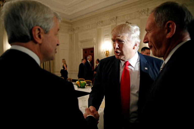 FILE PHOTO: U.S. President Donald Trump shakes hands with JPMorgan Chase & Co CEO Jamie Dimon (L) as he hosts a strategy and policy forum with chief executives of major U.S. companies at the White House in Washington February 3, 2017. REUTERS/Kevin Lamarque/File Photo