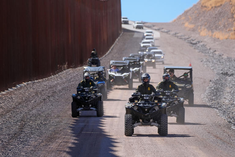 Noem, center, rides a four-wheeler during a tour along the border wall at the Mariposa Port of Entry in Nogales, Arizona, in 2025.