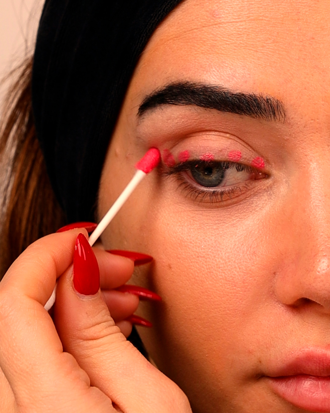 Applying eyeliner with a Q-Tip