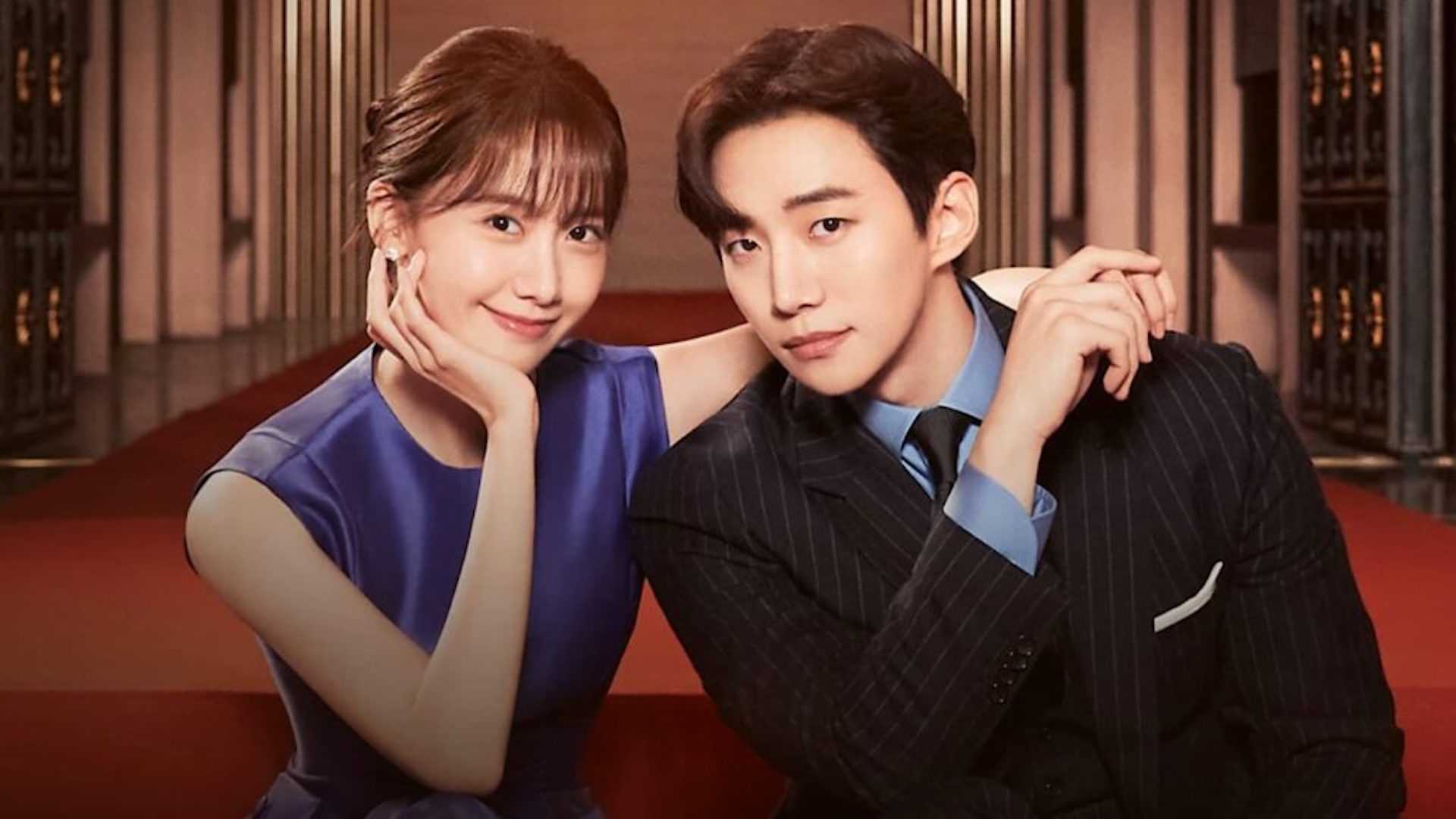 A man in a suit holding hands with a woman in a blue dress in the K-drama King The Land.