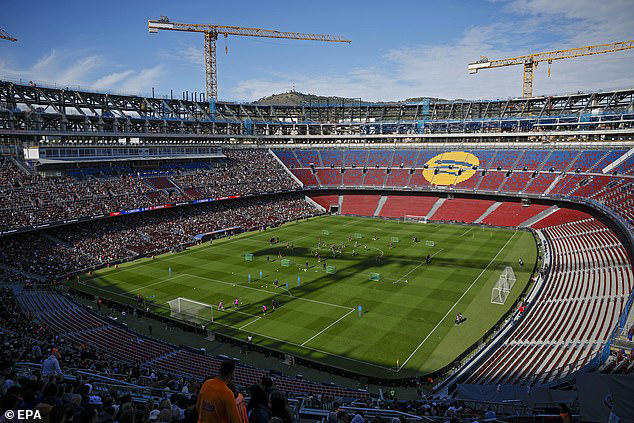 Barcelona's newly-renovated Nou Camp is flooded by heavy rain as ...