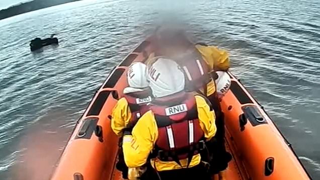 Moment man stranded on inflatable mattress is rescued by lifeboat crews