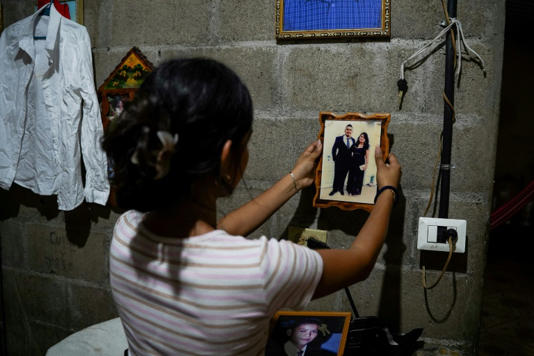 Jade, 16, holds a picture of her father Jose Roger Urquilla in her home in El Rosario, El Salvador, on December 3, 2025. El Salvador President Nayib Bukele's gang crackdown reduced violence to a minimum but has separated children from parents.