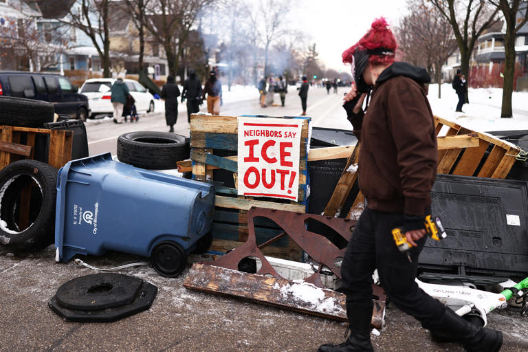 Neighbors who live near the street where Renee Good was killed say the community has had no time to recover. (Charly Triballeau / AFP via Getty Images)