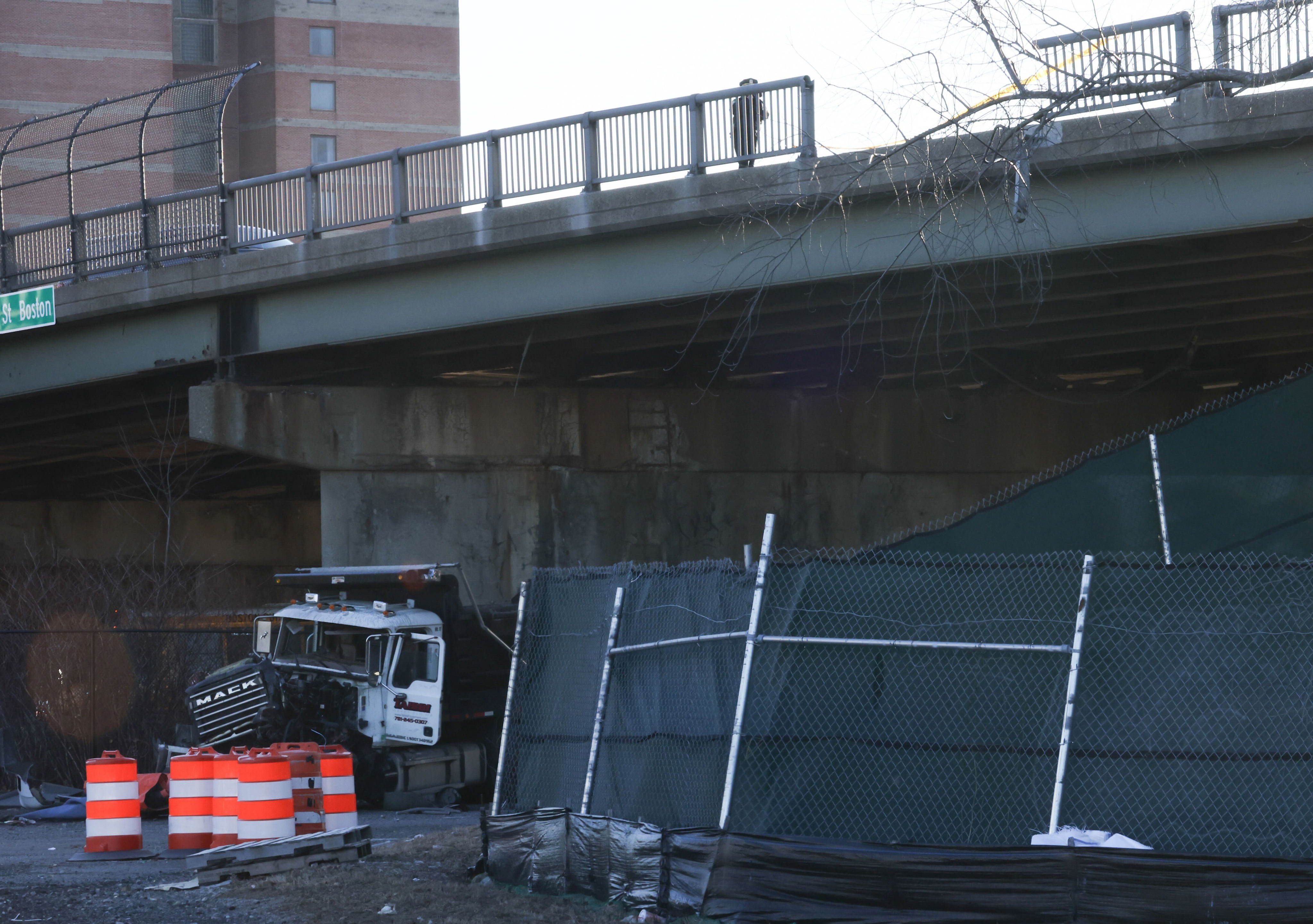 Dump truck crashes through guardrail, goes off overpass in Boston